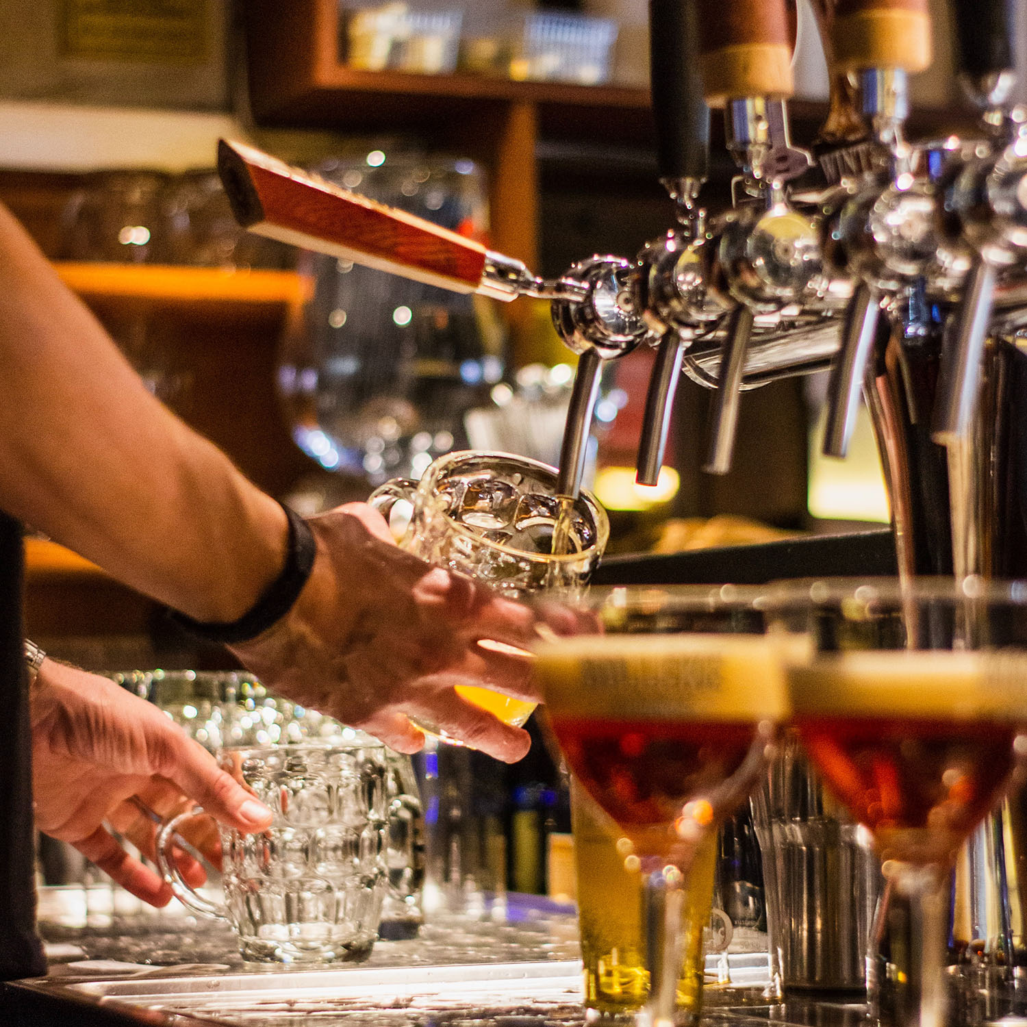 Pouring a beer at a bar tap